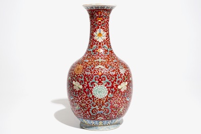 A Chinese red-ground famille rose bottle vase, Qianlong mark, 19/20th C.